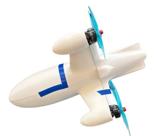 The printed drone assembled and unpainted, white PLA with blue tape, before the black paint